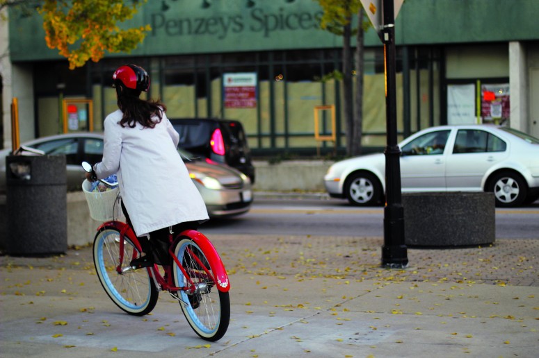 A woman rides her bike in downtown Oak Park.