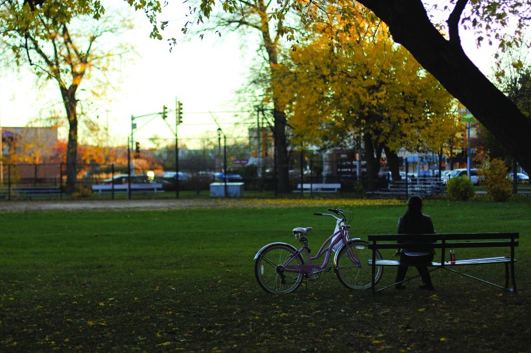 A woman enjoys a moment of silence at the park.